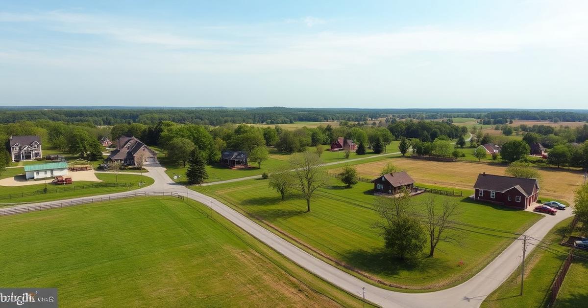 Aerial view of a rural Suffolk, Virginia neighborhood with large-lot homes, farmhouses, open fields, and forested horizon