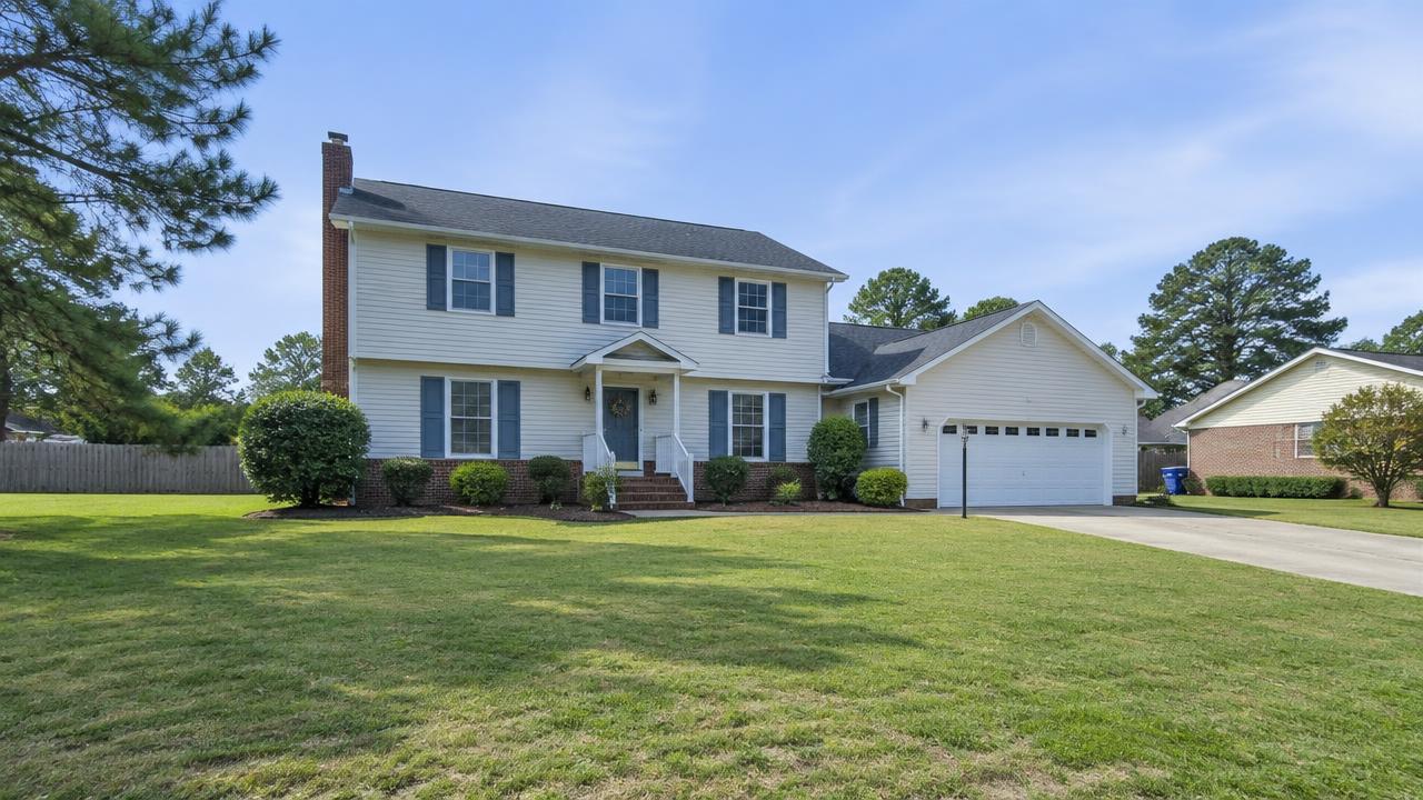 1980s suburban home with vinyl siding on a large flat lot in Butts Station, Chesapeake, Virginia