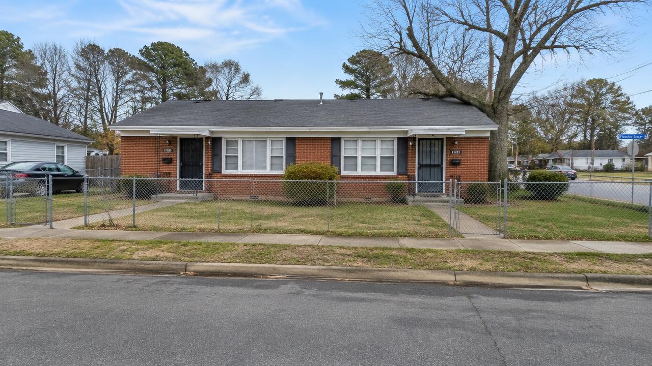 Small brick ranch duplex with chain-link fence on an older residential street in Diamond Springs, Virginia Beach, Virginia