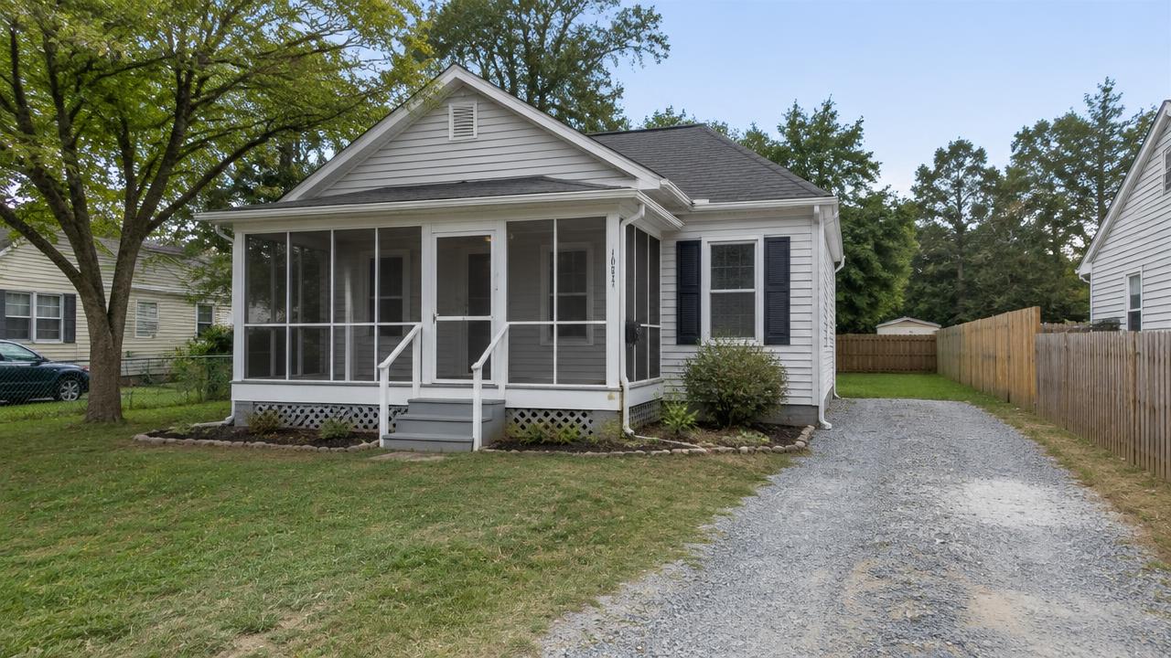 Small single story home with a screened porch and gravel driveway in Douglas Park, Portsmouth, Virginia