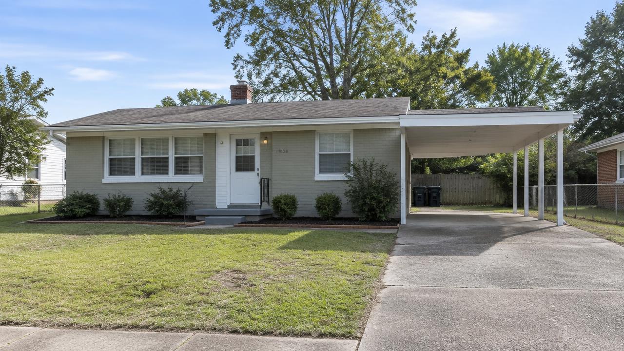 Small mid century starter home with white trim and a carport in Fairwood Homes, Portsmouth, Virginia