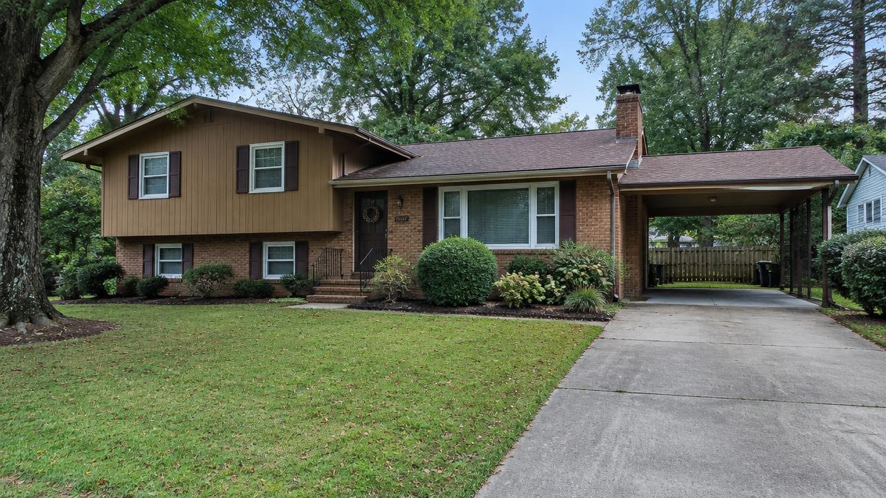 1970s split level home with a carport and mature landscaping in Georgetown, Chesapeake, Virginia
