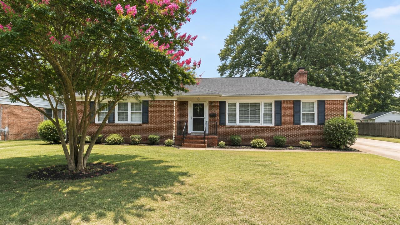 Post war brick ranch home on a flat lot with a mature crepe myrtle in Hodges Manor, Portsmouth, Virginia