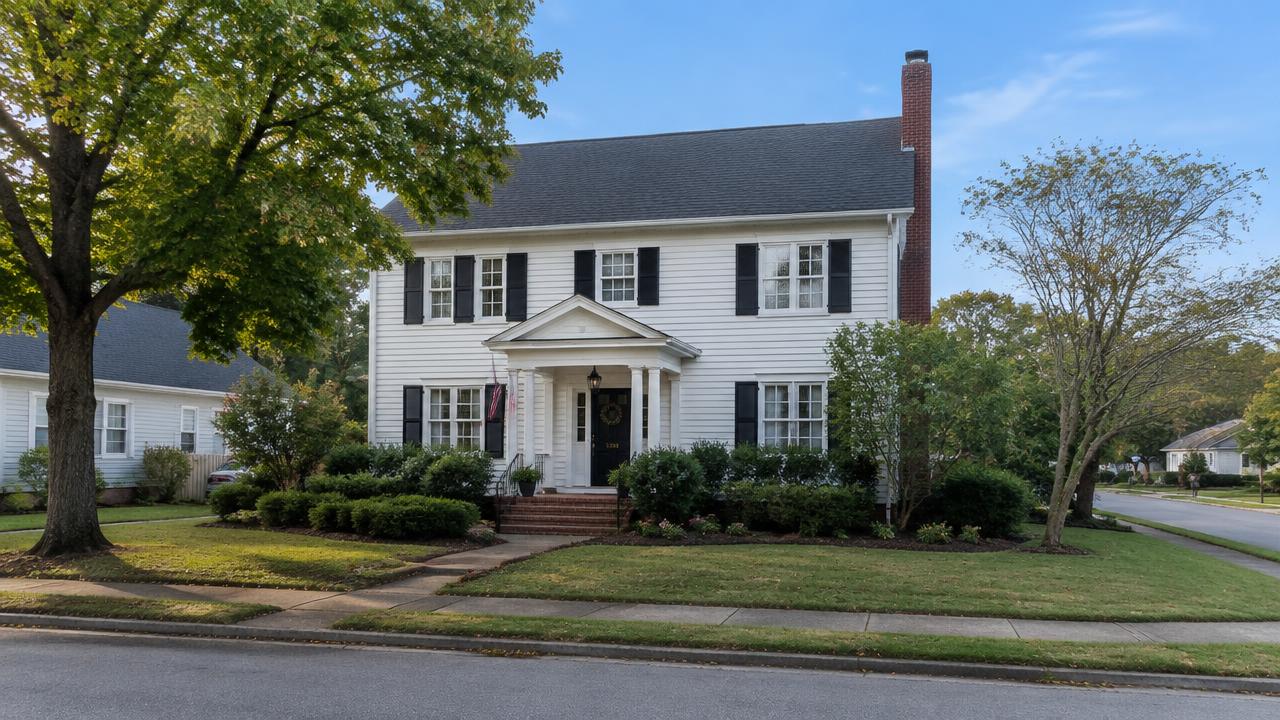 1930s colonial home with a brick chimney on a wide older street in Kecoughtan, Hampton, Virginia