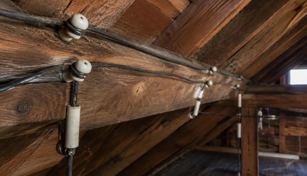 Original knob-and-tube wiring on ceramic insulators in the attic of an older Virginia home