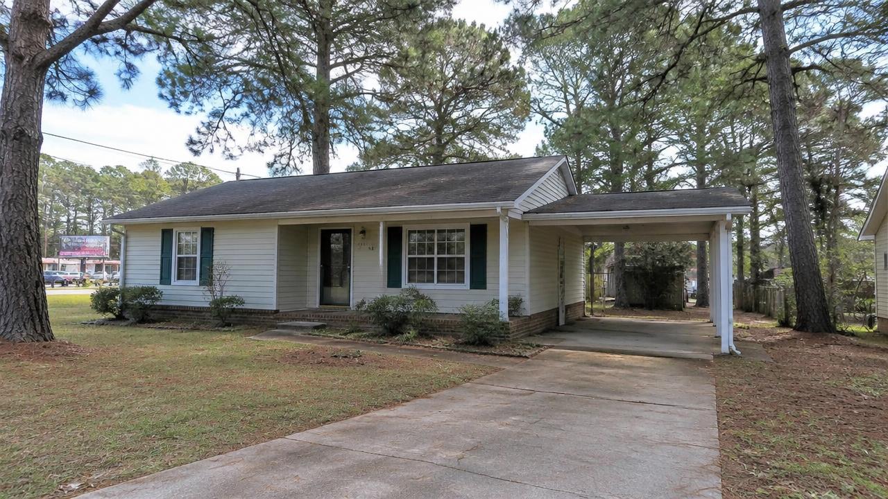 Modest older home with carport and mature pines near a busy corridor in London Bridge, Virginia Beach, Virginia