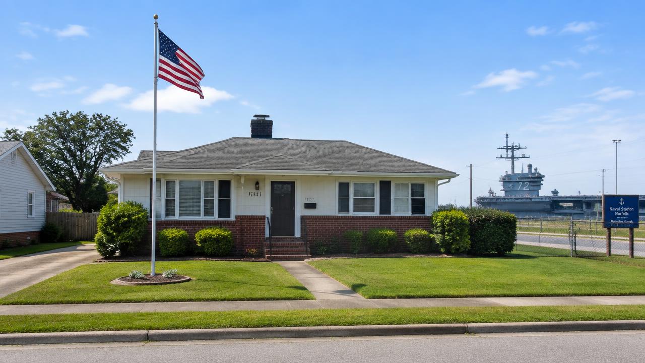 Post war home with a flagpole and a tidy lawn near a base in Magruder, Hampton, Virginia