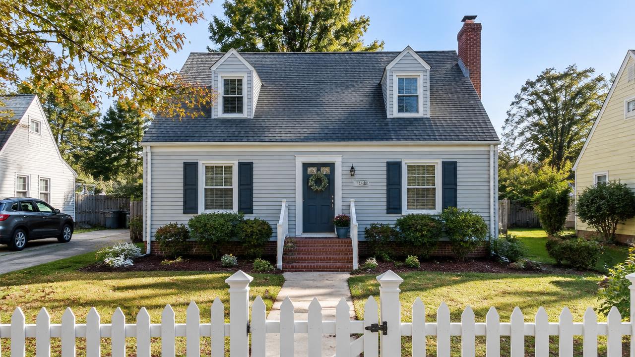 Small post-war cape cod home with a front stoop and picket fence in Oak Grove, Chesapeake, Virginia