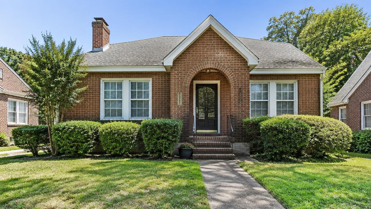 1930s brick bungalow with an arched entry and tidy hedges in Shea Terrace, Portsmouth, Virginia
