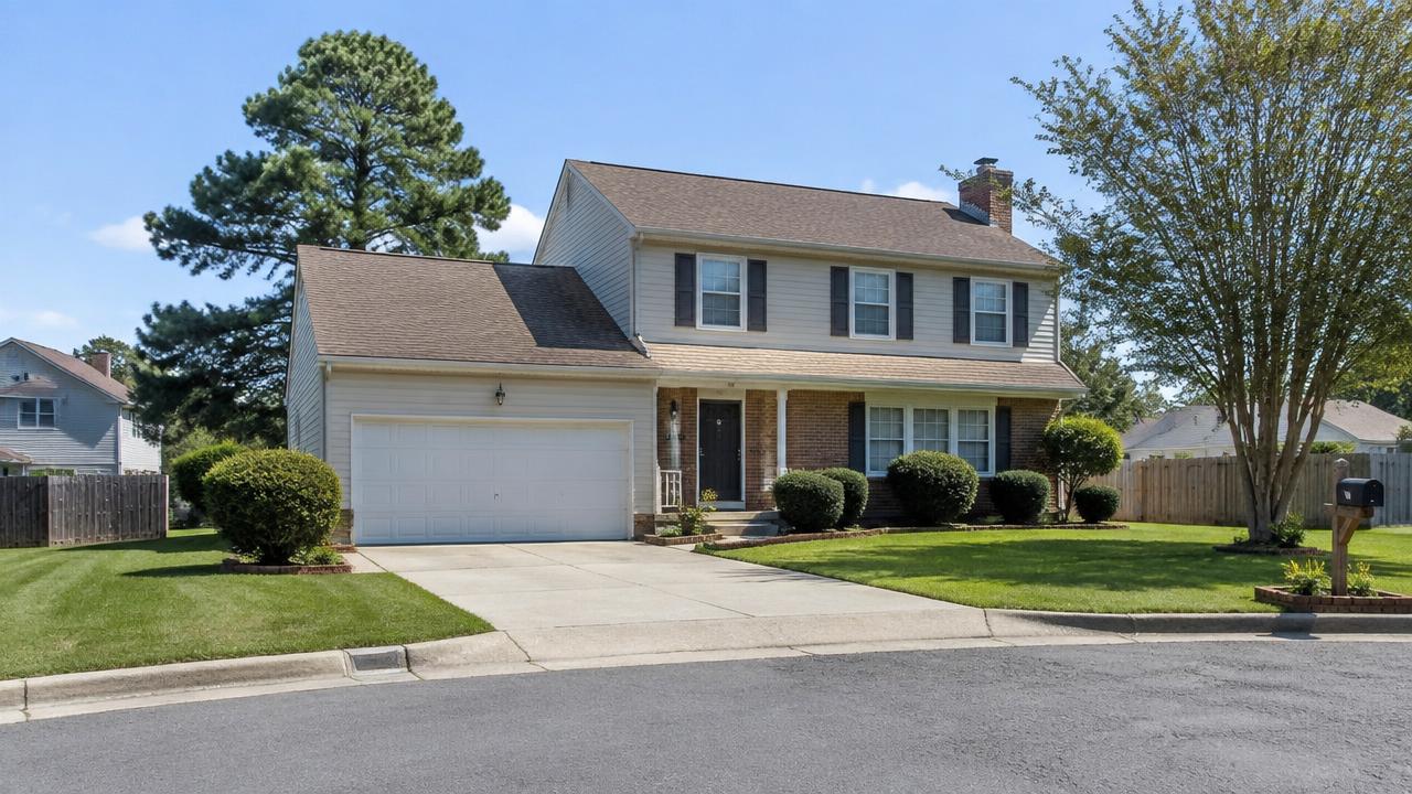 1980s two-story suburban home with attached garage on a tidy cul-de-sac in Strawbridge, Virginia Beach, Virginia