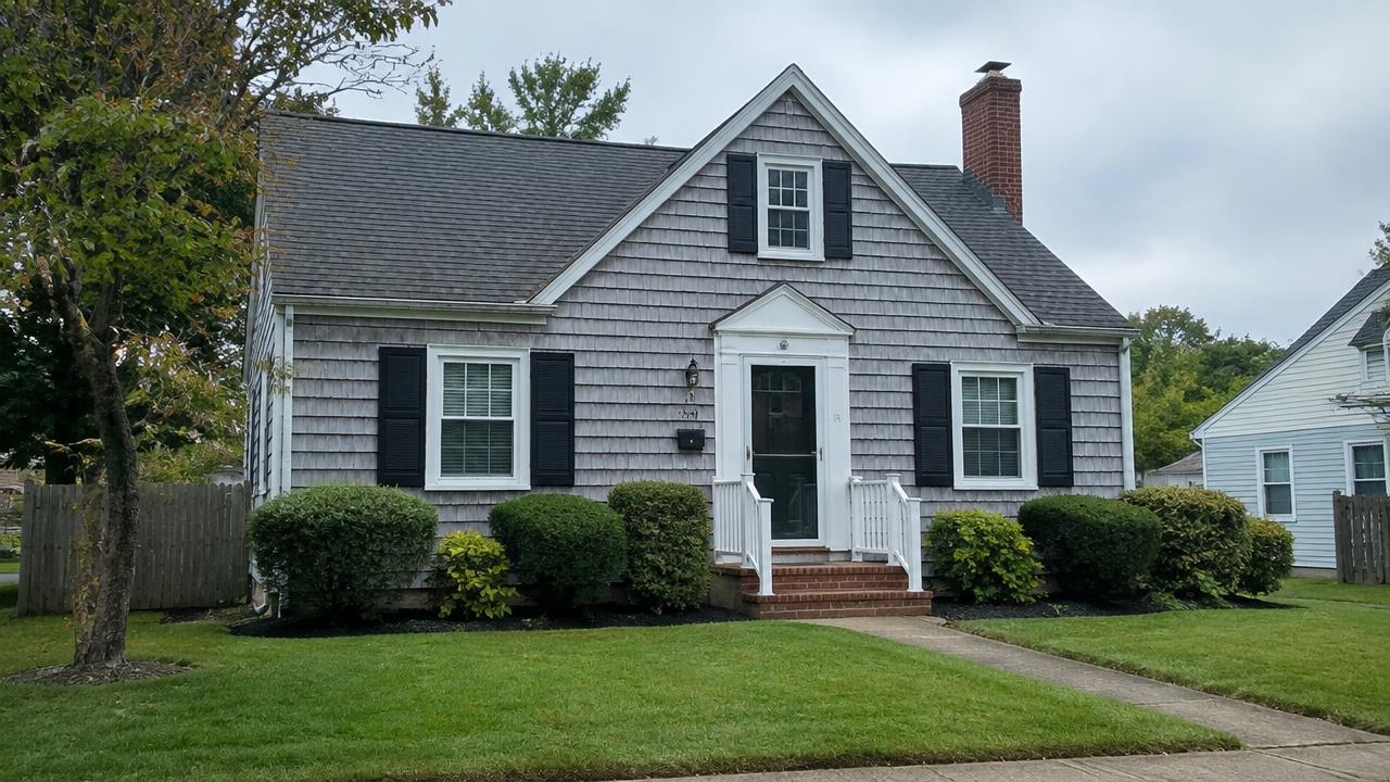 Small wartime-era cape cod home with a tidy front yard in Titustown, Norfolk, Virginia